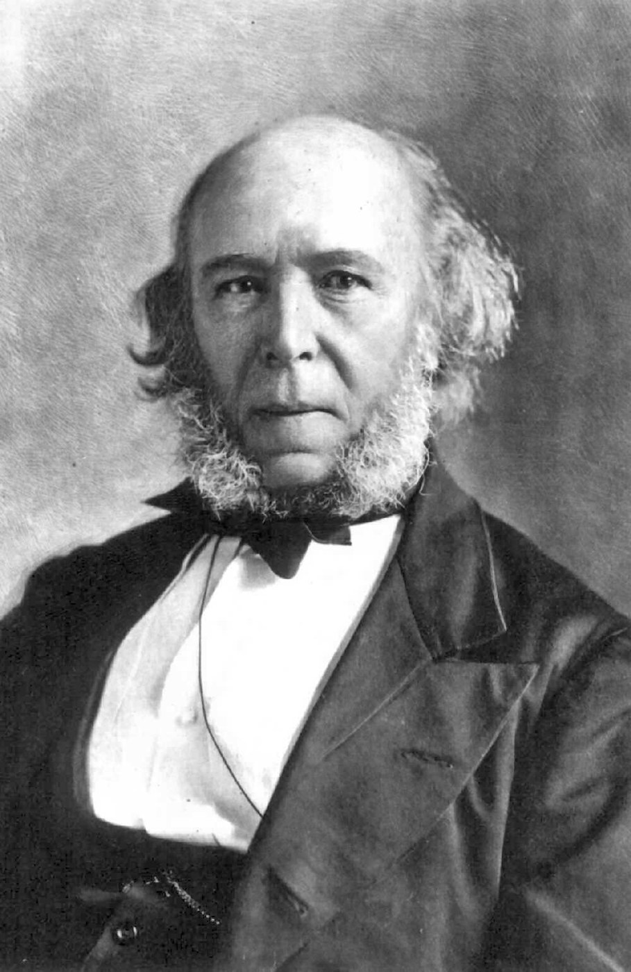 Schwarzweissporträt des älteren Herbert Spencer mit weissem Haar und ausgeprägten Koteletten.